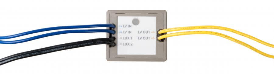 Low voltage lighting controller with labeled input and output connections for landscape lighting.