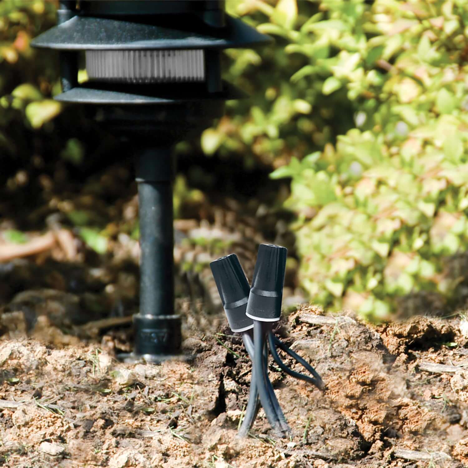 Close-up of King Industries waterproof wire connectors for landscape lighting in outdoor settings.