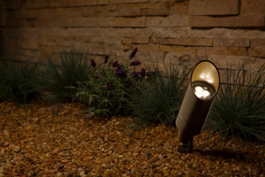 FX Luminaire MR16LED35WFL landscape lighting on a patio, highlighting plants with warm 2700K flood light.
